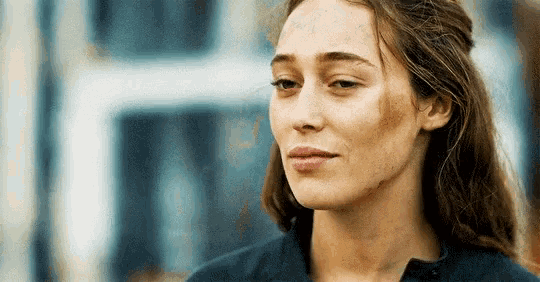 a close up of a woman 's face with a slight smile on it .