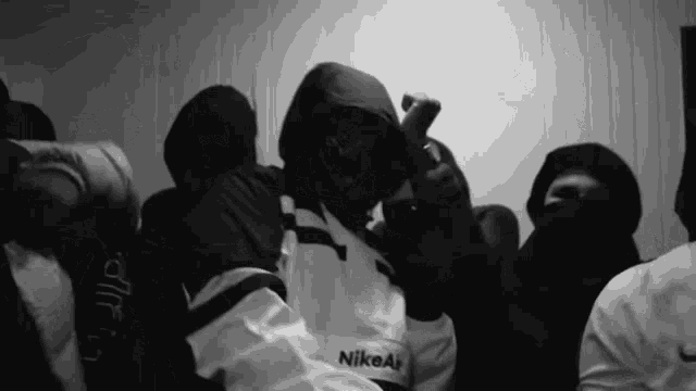 a black and white photo of a man wearing a nike air sweatshirt
