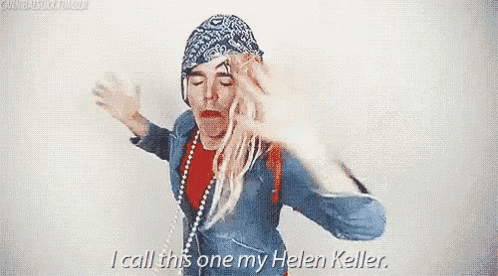 a woman with blonde hair and a bandana on her head is dancing and says i call this one my helen keller .