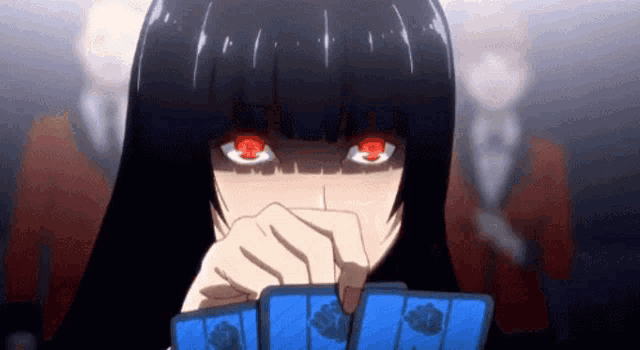 a girl with red eyes is holding a bunch of cards in her hand .