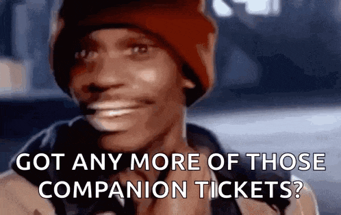 a man in a red hat is smiling and asking if he has any more companion tickets .