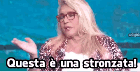 a woman wearing glasses says questa e una stronzata !
