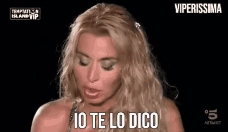 a woman with blonde hair is making a funny face and says `` io te lo dico '' .
