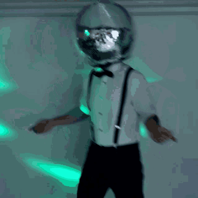 a man with a disco ball on his head dancing