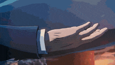 a close up of a person 's hand touching another person 's shoulder