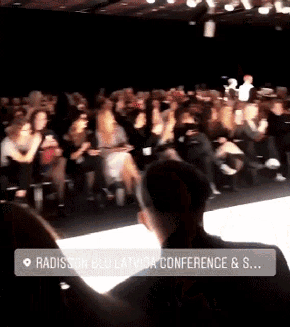 a crowd of people watching a fashion show at radisson blu latvia conference & s