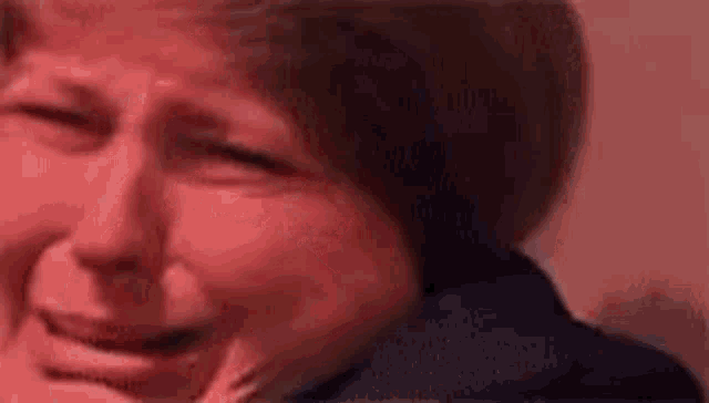 a close up of a woman 's face with a red background .