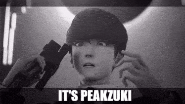 a black and white photo of a person with the words it 's peakzuki written above them