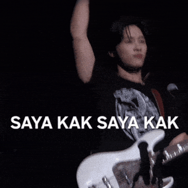 a man playing a guitar with the words saya kak saya kak written above him