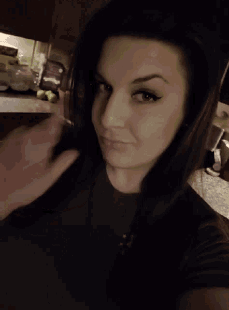 a woman in a black shirt is making a face