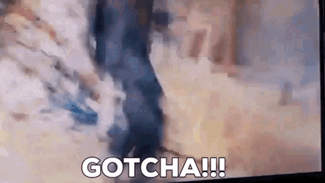 a blurry picture of a person walking with the words `` gotcha ! '' written on the screen .
