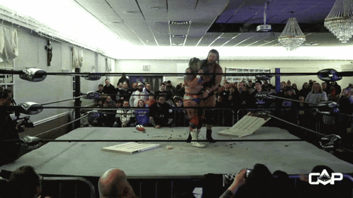 a man in a wrestling ring with the word cap on it
