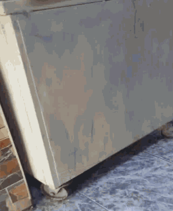 a blurred image of a person standing next to a dresser