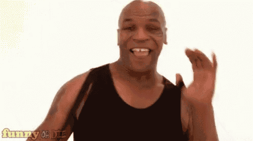 a man in a black tank top is smiling and making a funny face .
