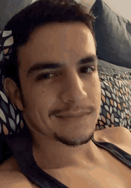 a man with a beard is laying on a bed