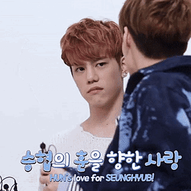 two young men are standing next to each other and one of them says hun 's love for seunghyue