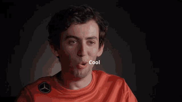 a man wearing an orange shirt with the word fun written on it