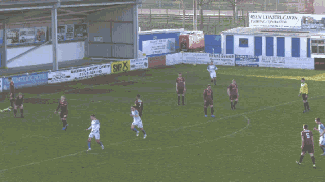 a soccer game is being played on a field that has a sign that says ' allier bank ' on it