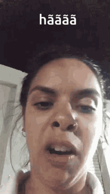 a close up of a woman 's face with the word haaaa on the bottom right