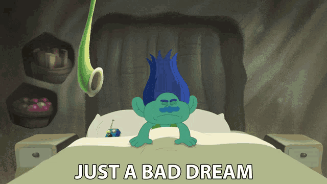 a troll laying on a bed with the words just a bad dream above him