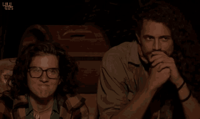a man and a woman are sitting next to each other and the words lulu gifs are on the bottom