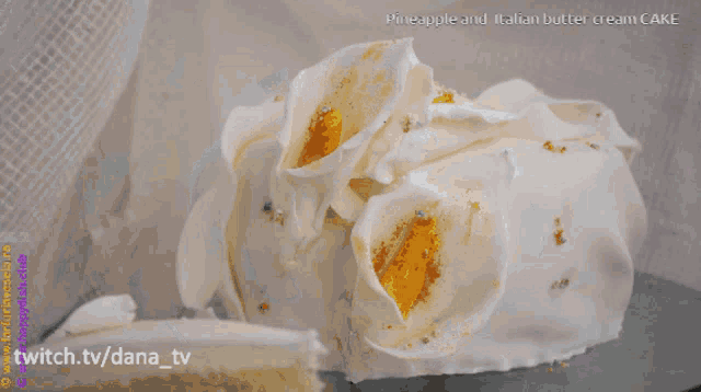 a pineapple and italian butter cream cake with flowers on top