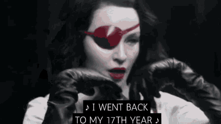 a woman wearing a red eye patch and gloves says i went back to my 17th year