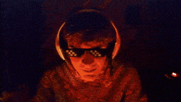 a person wearing headphones is standing in a dark room