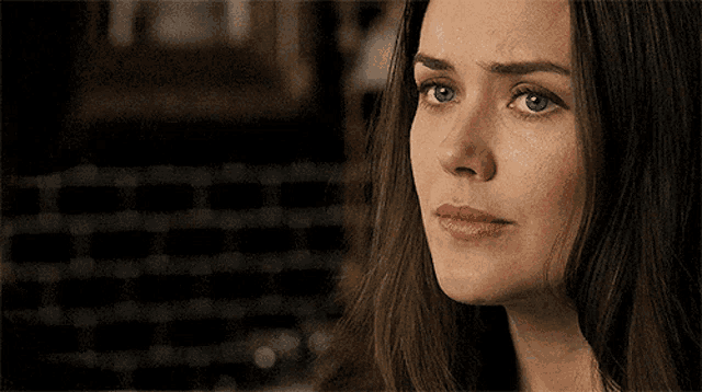 a woman with a sad look on her face