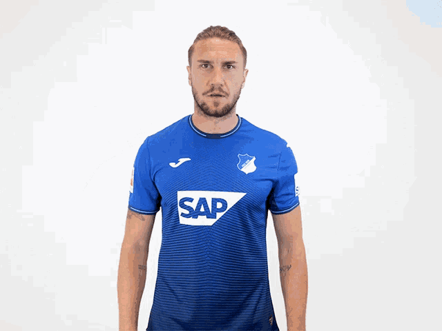 a man wearing a blue shirt with the word sap on the front