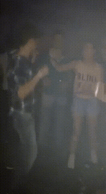a blurry picture of a person playing a guitar in a dark room