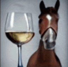 a horse is standing next to a glass of white wine