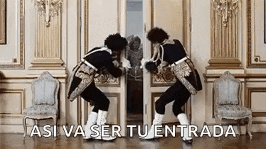 two men in medieval costumes are dancing in front of a door in a room .