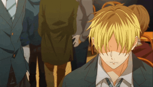 a man with blonde hair is covering his face with his hands