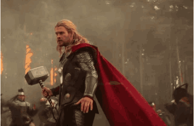 thor is holding a hammer in his hand in a scene from the movie thor .