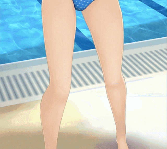a woman in a blue polka dot bikini stands in front of a pool