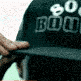 a person is wearing a black hat that says 80 % bouncy