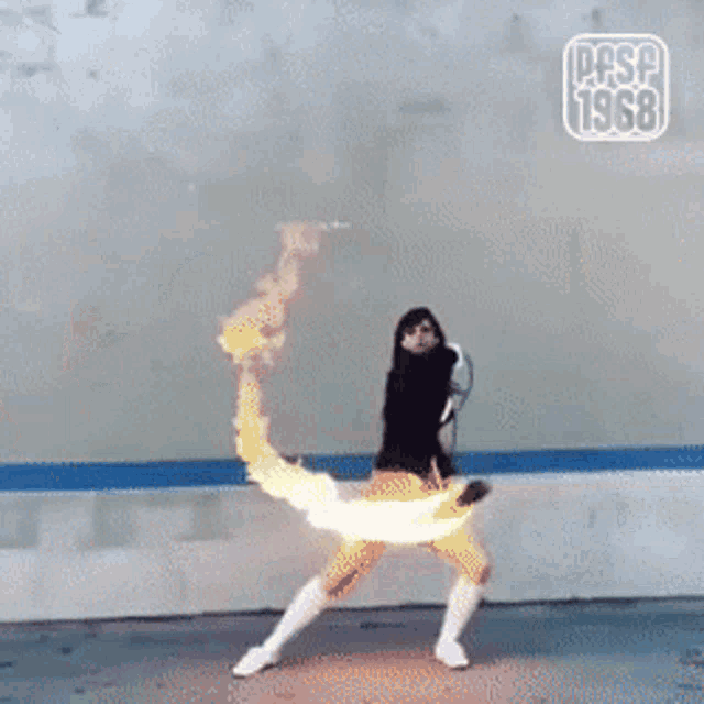 a woman is dancing in front of a wall that says pfsp 1968 on it
