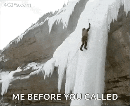 a man is climbing up the side of an iceberg .
