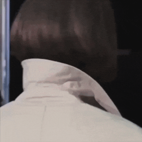 a close up of a person 's neck with a white shirt