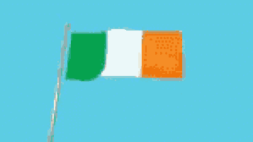 a green white and orange flag waving in the wind