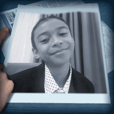 a black and white photo of a young boy in a suit and tie