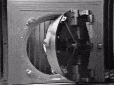 a black and white photo of a bank vault door