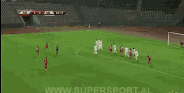 a soccer game is being played on a field with the website www.supersport.al in the corner
