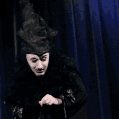 a man wearing a black hat and a black robe