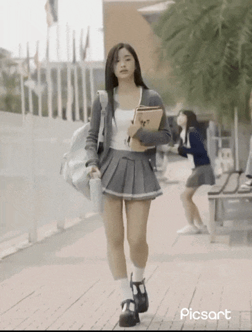 a girl in a school uniform is walking down a sidewalk with picsart written on the bottom right