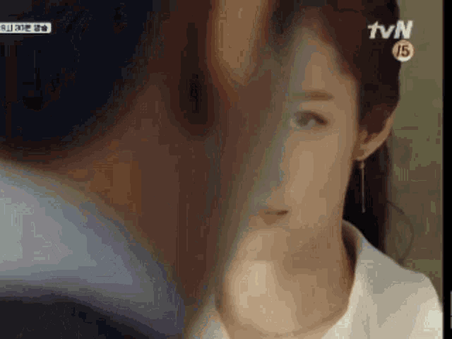 a close up of a woman 's face with a tvn logo in the corner