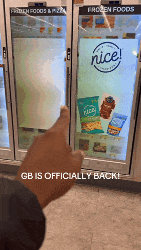 a person is pointing at a nice sign on a refrigerator