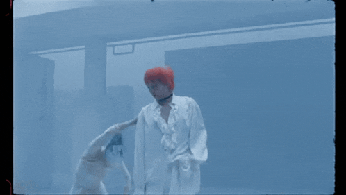 a person with red hair is sitting next to another person