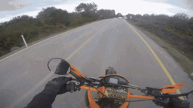 a person riding a dirt bike with a rockstar energy drink sticker on the handlebars